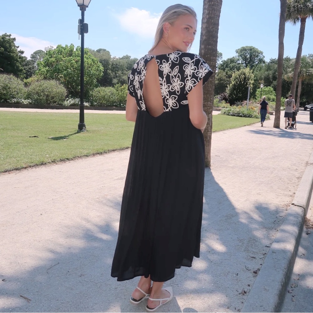 By February: Elegant Black and White Floral Dress with Embroidered Stitching.
